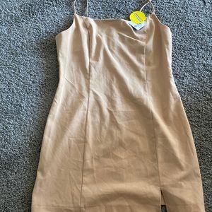 Tan mini dress with a cute little split. Would be cute with a white shirt😌